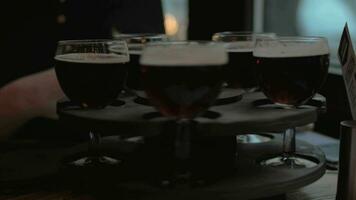 In cafe on table is a rotating tray of drinks, girl twists the tray and selects a glass video