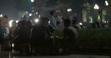 People having food and drinks in roadside cafe Hanoi, Vietnam video