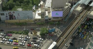 Bird eye view of big road with a lot of cars, trucks and moving train on railways video