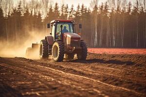 Farmer in tractor preparing land with seedbed cultivator at spring photo