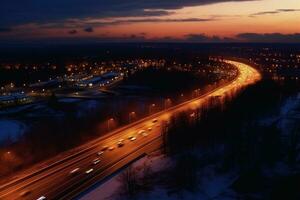 Aerial view of highway and cityscape at dusk. Top view photo