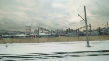 Passing by the railway tracks with trains, Russia video