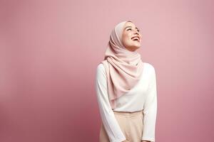 beautiful asian muslim woman smiling and looking up isolated on pink background AI Generated photo