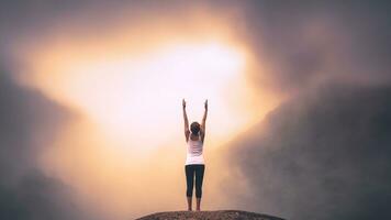 Asian women relax in the holiday. Play if yoga. On the Moutain rock cliff photo