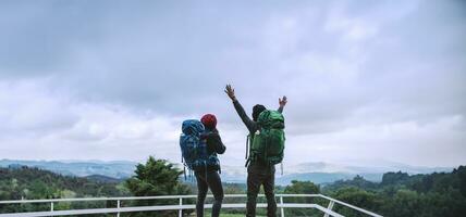 Asian couples travel nature on the mountains in winter.Travel relax. Natural touch countryside at doi inthanon in Thailand. photo