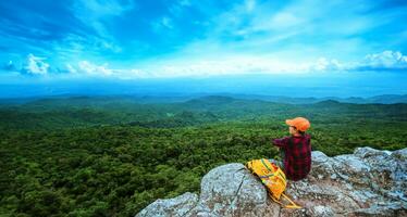 woman asians travel relax in the holiday. View mountain nature on the cliffs. photo