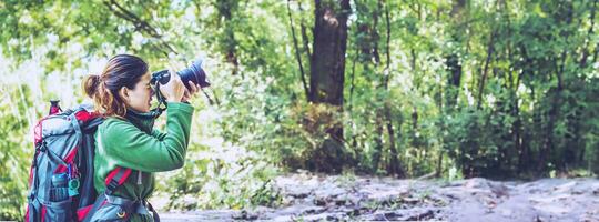 photographer Asian women Traveling photograph Nature. travel relax in the holiday walk in the forest. Thailand photo