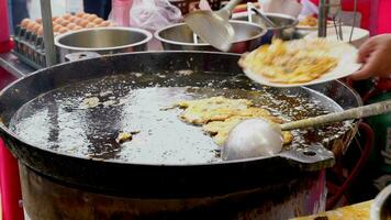 Thai oyster omelet or hoy tod on street food market video