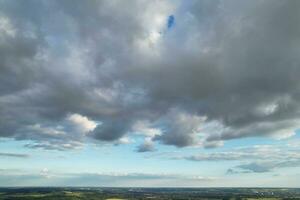 Most Beautiful High Angle view of Dramatical Sky and Clouds over British Countryside Landscape During Sunset photo