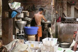 Magelang, Indonesia.09 18 2023-tofu factory employees are starting activities to make typical Indonesian tofu. photo