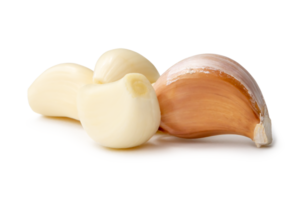 Front view of fresh garlic cloves in stack isolated with clipping path and shadow in png file format Close up photo