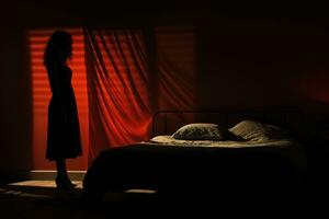 Shadowy figure looming over sleeping figure background with empty space for text photo