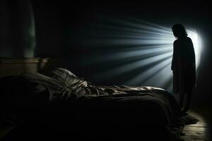 Shadowy figure looming over sleeping figure background with empty space for text photo