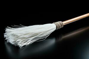 An elegant white broom interpretation isolated on a black gradient background photo