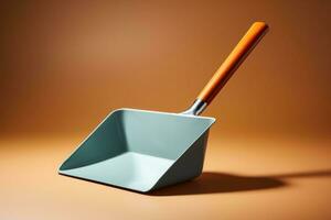 A simple metal dustpan isolated on a silver gradient background photo