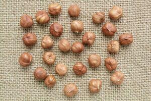 Hazelnut nuts on canvas background. Healthy diet, nutrition, vegan concept. Protein dry organic snack. Raw food photo