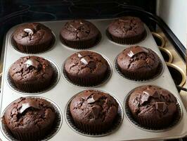 A Muffin Tin Filled With Chocolate Cupcakes On Top Of A Stove. AI Generated photo
