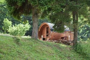 Outdoor Wooden Barrel Sauna with Bathtub in Garden photo