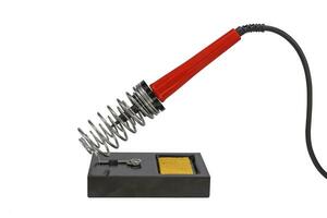 Soldering iron stand with red electric solder isolated on a white background photo