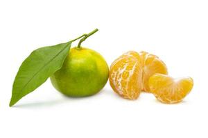 Whole and peeled green tangerines on isolated white background photo