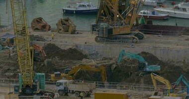 In Hong Kong, China are going construction work - excavators digging ground video