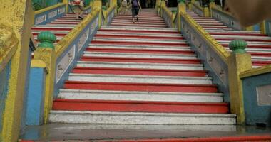 Woman with pad making photo of Batu Caves entrance, Malaysia video