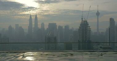 Woman bathing in rooftop pool Kuala Lumpur, Malaysia video