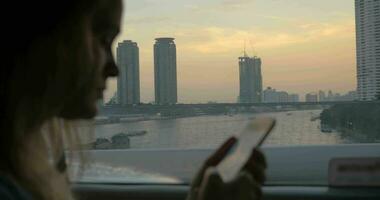 Woman texting on cell during bus travel in Bangkok, Thailand video