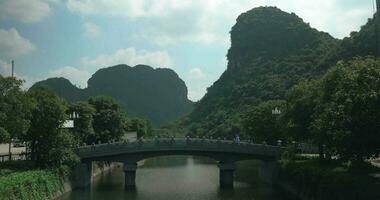 Man crossing the bridge in Trang An, Vietnam video