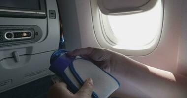 Shot of woman opening disposable slippers in airplane video