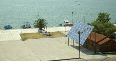 solar painéis estão fixo Próximo para a casa, dentro a fundo é uma calma mar video