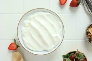 Greek Yoghurt on White Bowl with Fresh Strawberry and Granola. photo