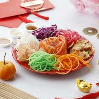 Yusheng, Yee Sang or Yuu Sahng usually Consists of Strips of Raw Salmon Fish photo