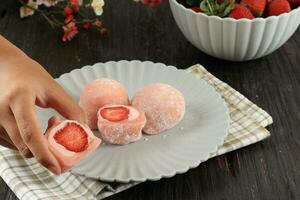 Female Hand Take Strawberry Daifuku Mochi photo