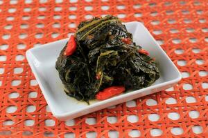 Buntil Daun Pepaya, Boiled  Papaya Leaves with Spiced Shredded Coconut Inside photo