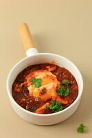 Poached Eggs in Sspicy Tomato Pepper Sauce. photo