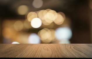 Mock up for space. Empty dark wooden table in front of abstract blurred bokeh background of restaurant . can be used for display or montage your product photo