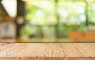 Mock up for space. Empty dark wooden table in front of abstract blurred bokeh background of restaurant . can be used for display or montage your product photo