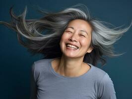 50 year old asian woman in emotional dynamic pose on solid background AI Generative photo