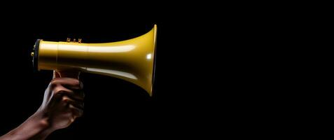 Generative AI, golden megaphone in hand on a empty black background, panoramic image with copy space photo