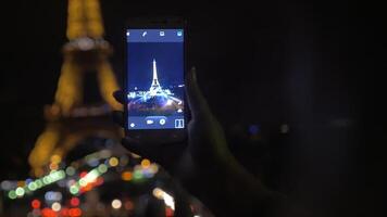 Night shot of illuminated Eiffel Tower on mobile video