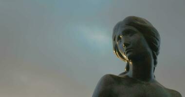 Face of Little Mermaid statue against sky background video