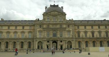 Tourists walking by the Louvre Museum video