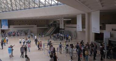 Visitors in the underground hall of Louvre Pyramid video