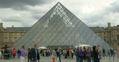 Crowd of tourists at the Louvre Pyramid video