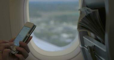 Woman typing sms in flying plane video