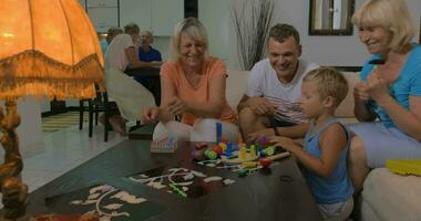 garçon et le sien famille en jouant avec jouets à Accueil video