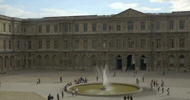 People on the Louvre square with fountain video