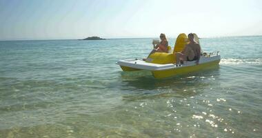 Family enjoying sea ride on pedal boat video