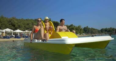 Family with child enjoying pedal boat ride video